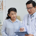 Doctor discussing personalized primary care services with a patient during a longer primary care consultation